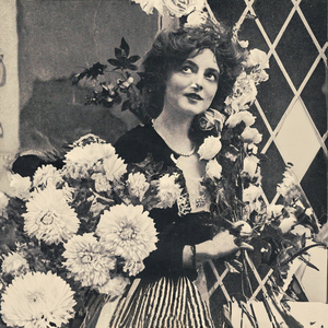 Everything Blooms Around Her