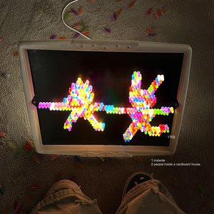 People inside a cardboard house